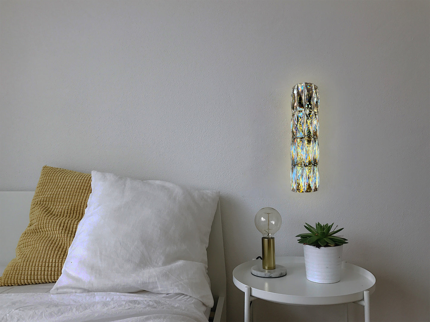 Slim crystal wall light in contemporary dark bedroom