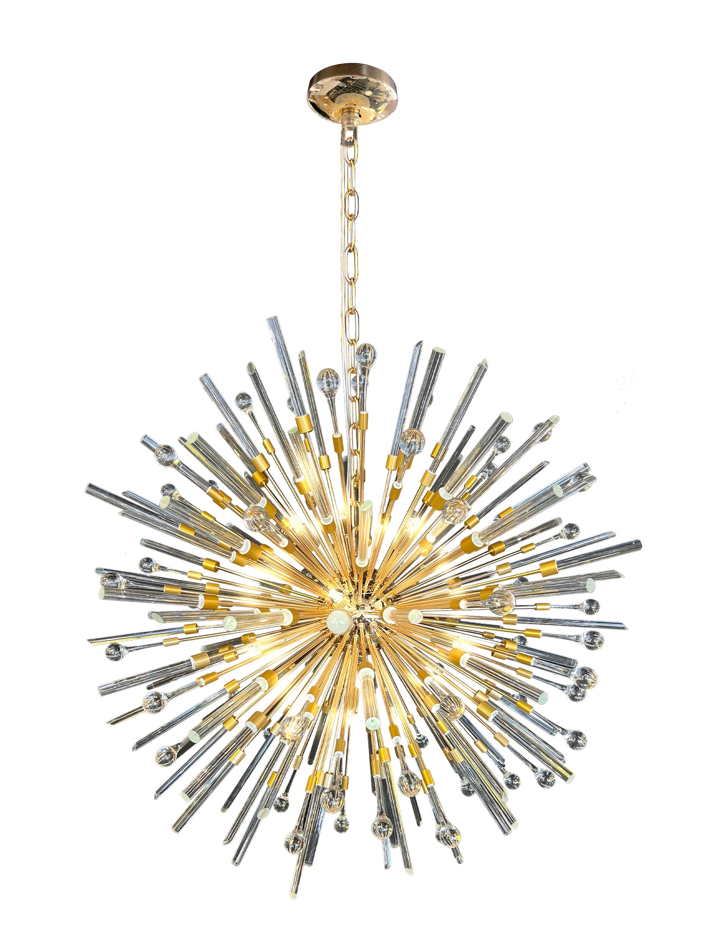 Side view of luxury gold pendant chandelier showcasing warm lighting.