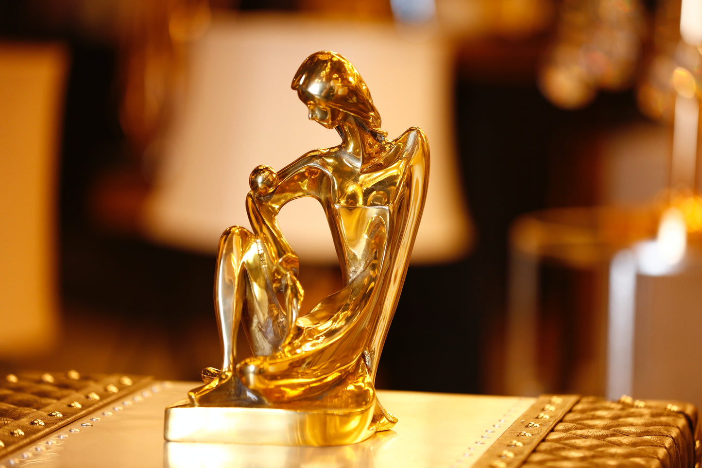 Detailed view of the modern Italian brass lady statue showing the brilliant gold finish.