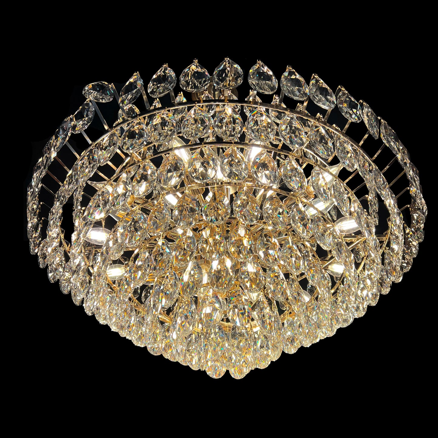 Close-up of 31 inch champagne gold crystal chandelier with teardrop crystals and empire-style design.