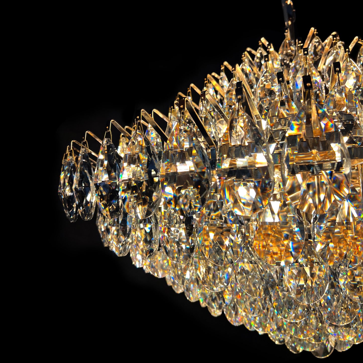 Detailed close-up of 31 inch champange gold crystal chandelier showing stainless steel frame, teardrop crystals, and E12 bulb sockets.