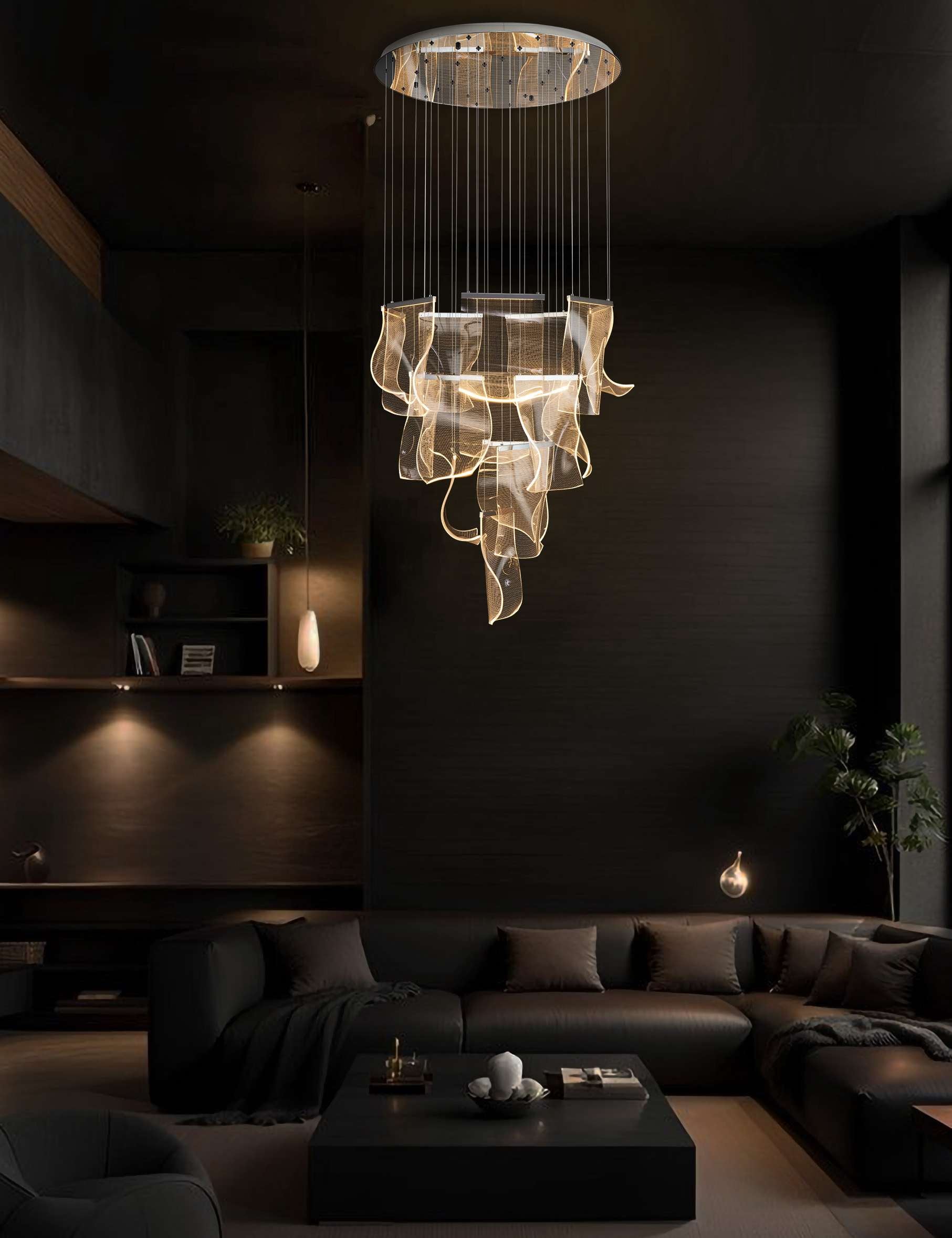 Modern chrome LED wave chandelier illuminating a dark luxury living room with cascading acrylic panels