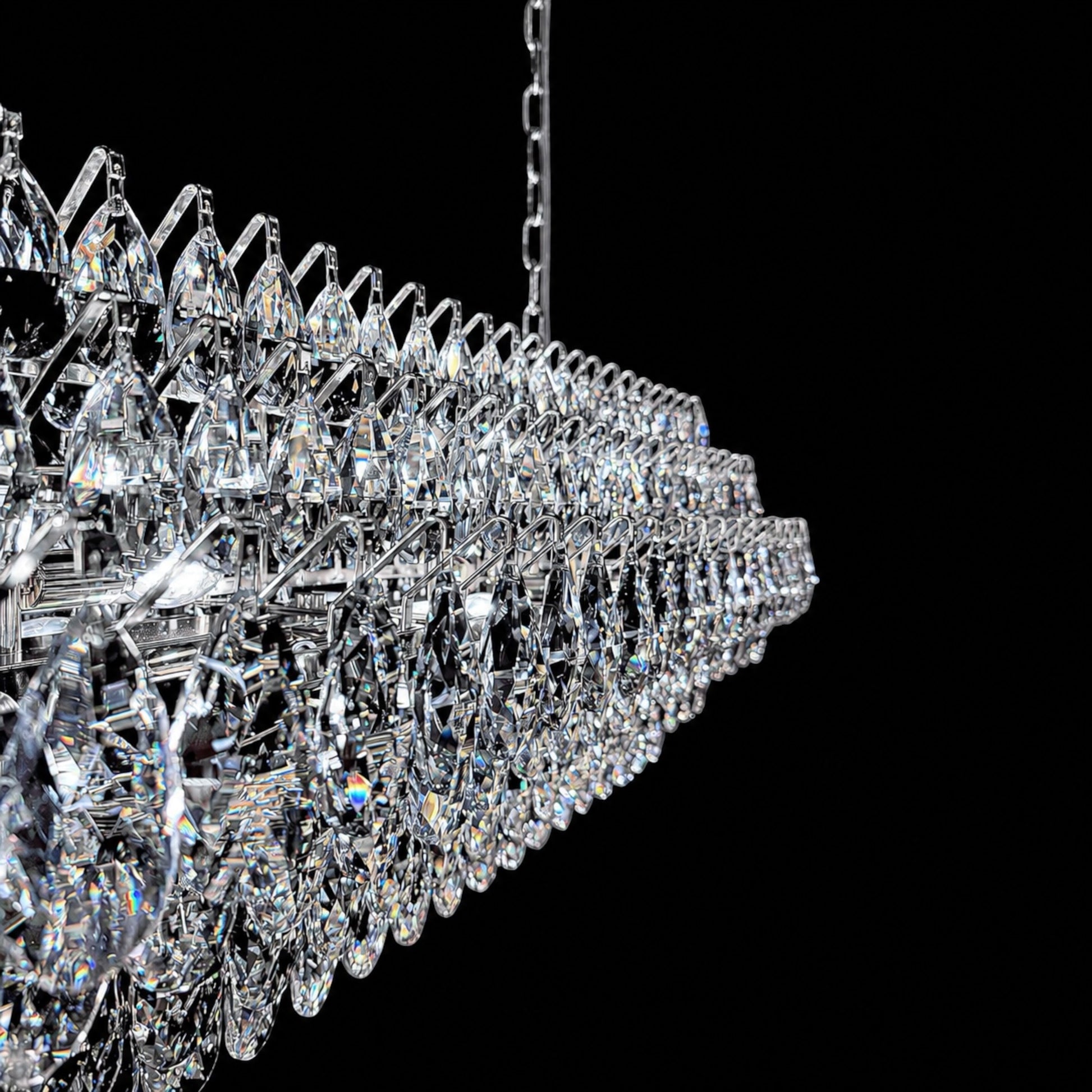 A close-up view of the luxury crystal chandelier's frame, showing precision-cut teardrop crystals securely attached to a polished chrome structure.
