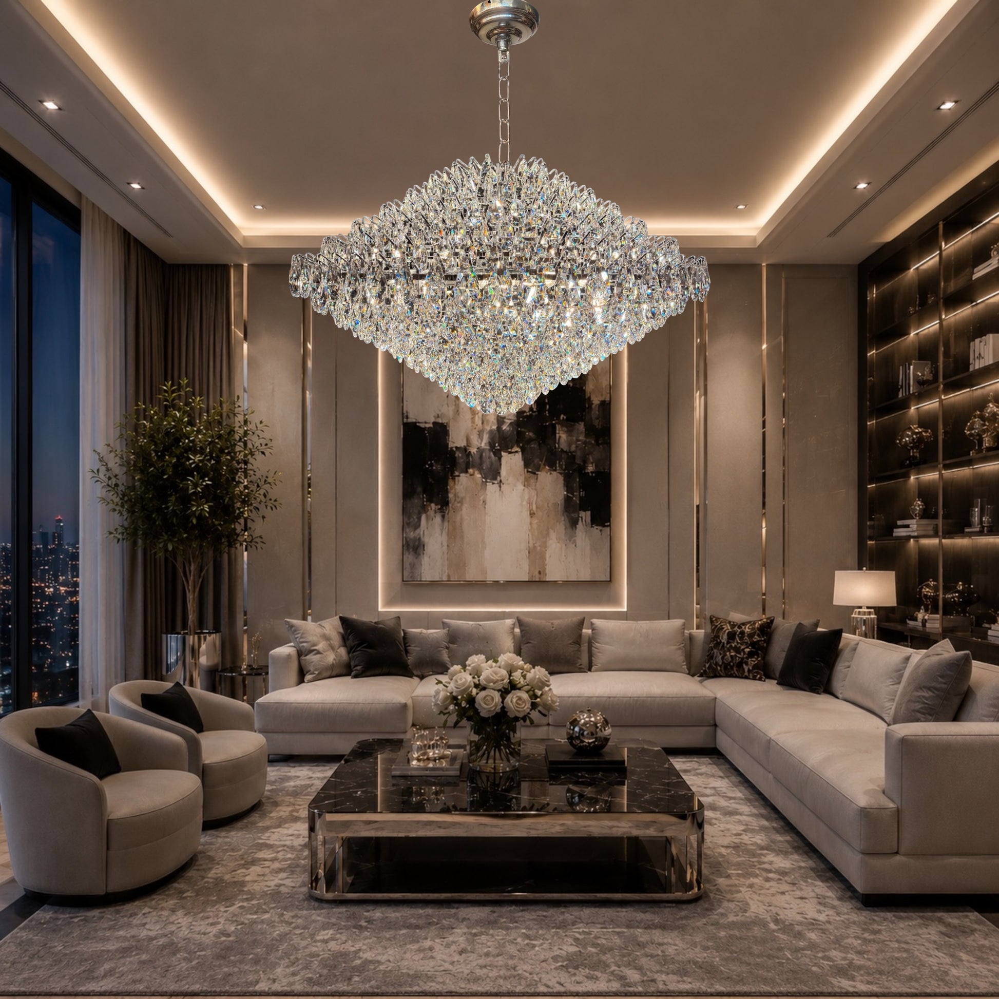 Grand luxury living room featuring a large diamond-shaped crystal chandelier hanging above curved white sofas, a round marble coffee table, and elegant dark accent chairs.
