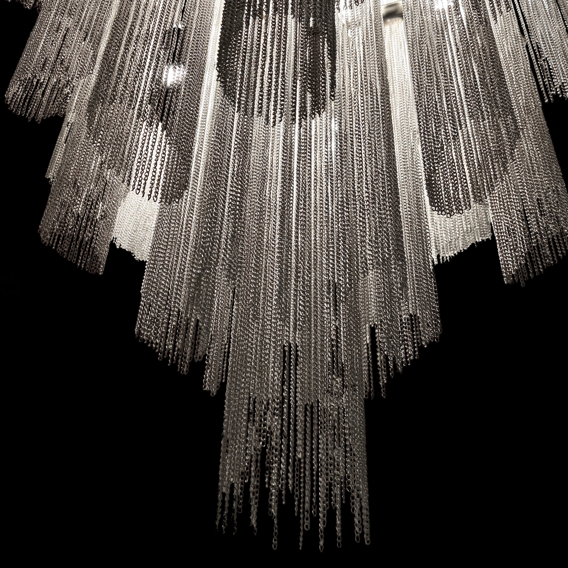 Close-up view showing the polished chrome finish and cascading metallic chains of the luxury waterfall chandelier.
