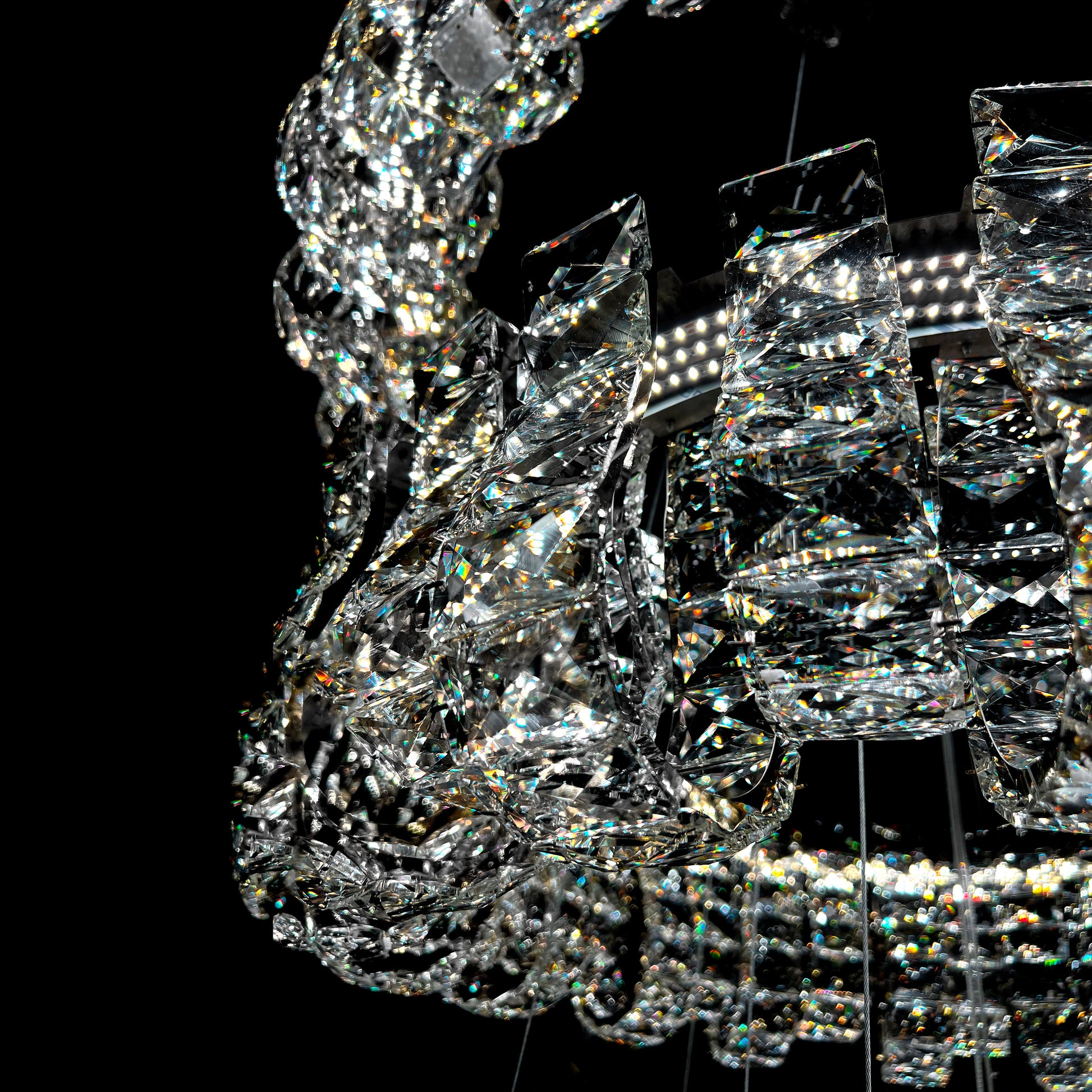 Close-up of a crystal chandelier against a black background