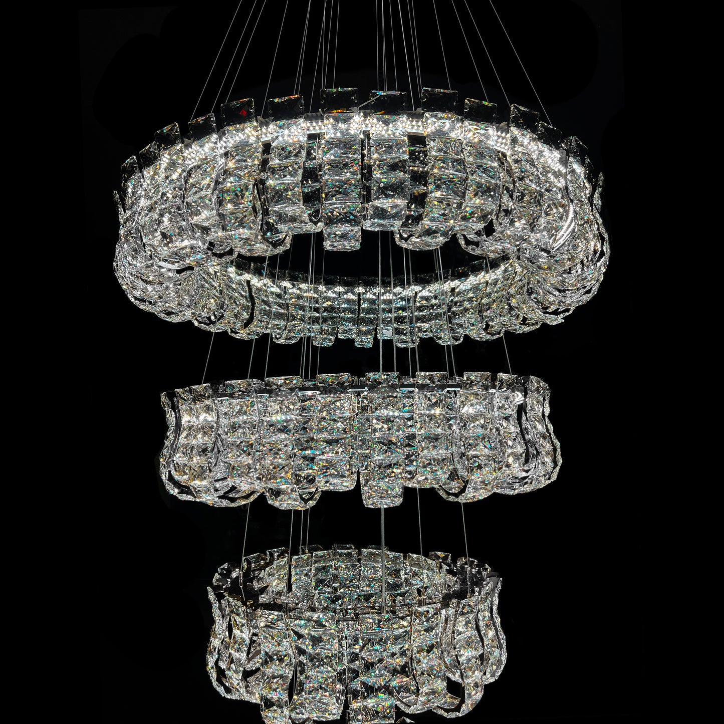 Crystal chandelier with multiple tiers on a black background