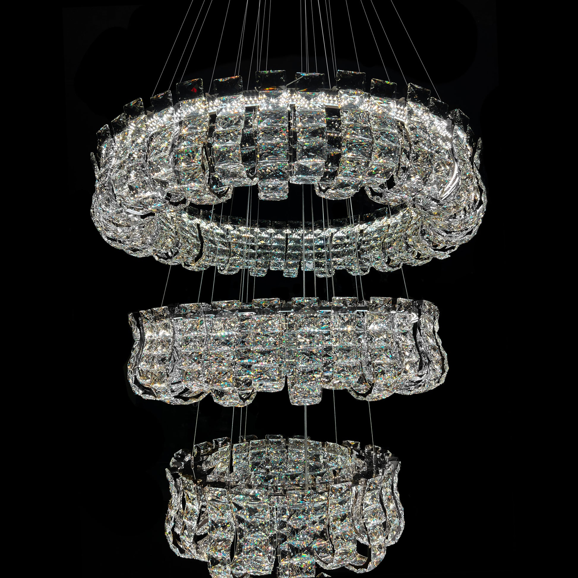 Crystal chandelier with multiple tiers on a black background