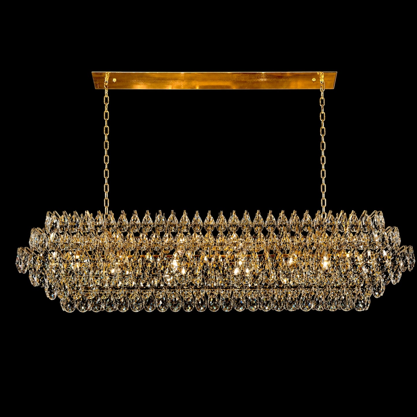 A luxurious 60-inch linear crystal chandelier featuring a polished gold frame and multiple tiers of precision-cut teardrop crystals, shown hanging from a rectangular canopy with dual chains against a solid black background.