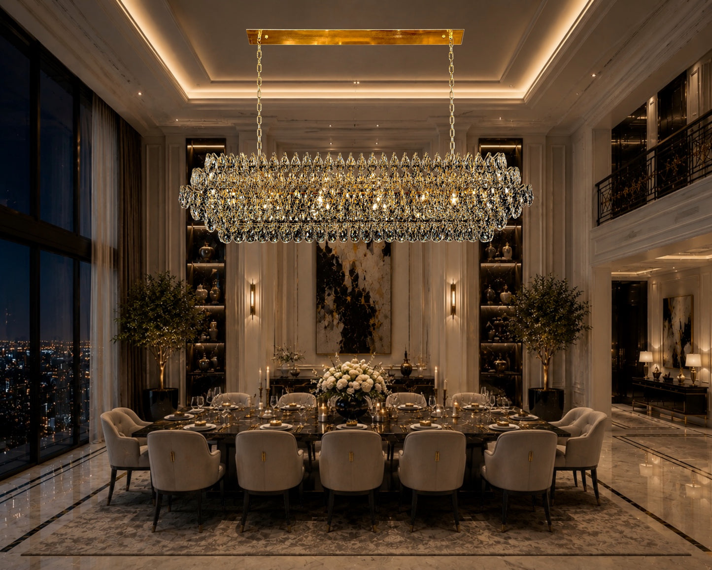 A luxurious linear crystal chandelier with a champagne gold frame illuminated over a large, elegant dining table with beige chairs in a modern, high-ceiling luxury dining room with large windows.