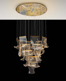 Close-up detail of dimmable LED chandelier featuring layered acrylic wave panels and adjustable hanging cables.