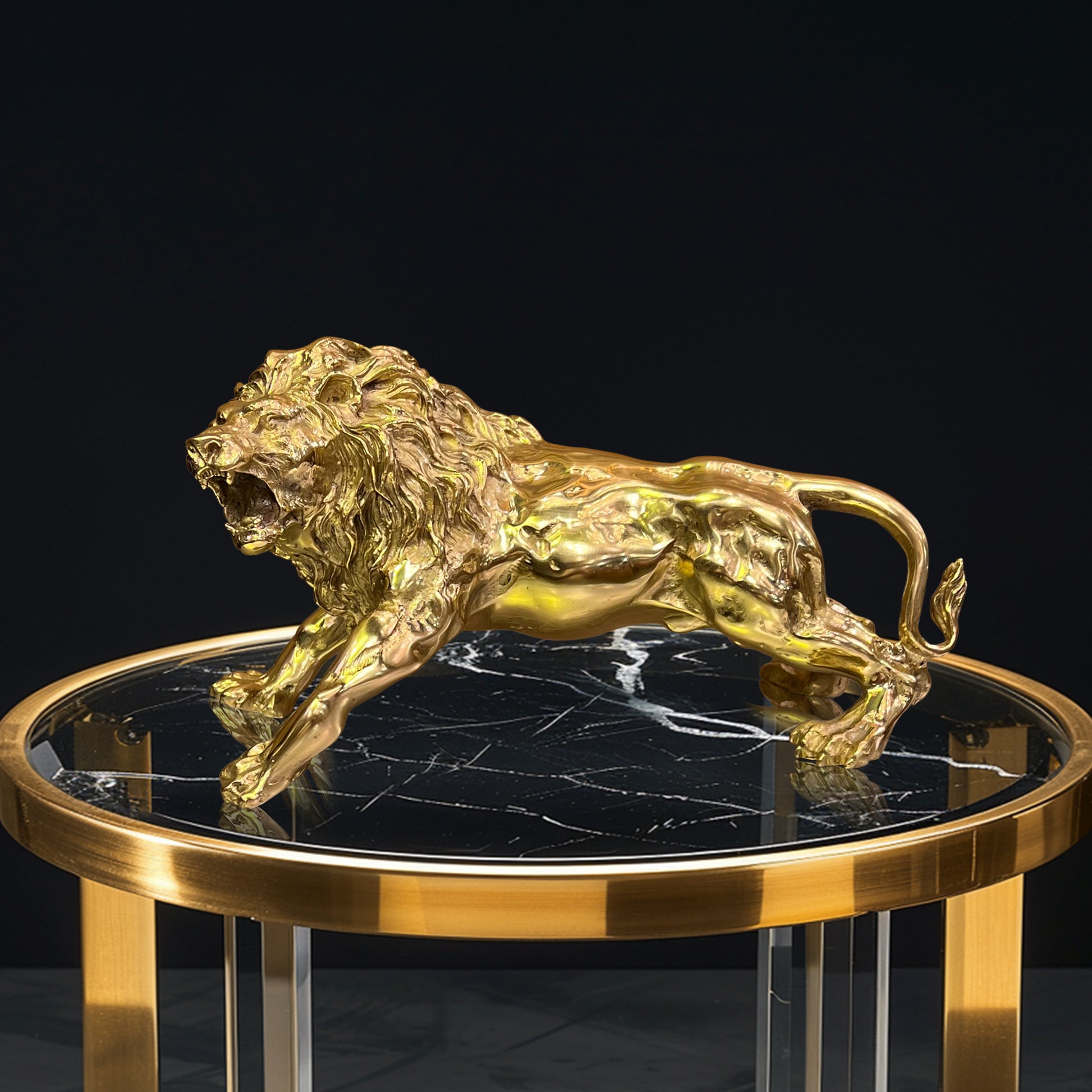 Gold brass lion sculpture displayed on a marble luxury side table for home interior design.
