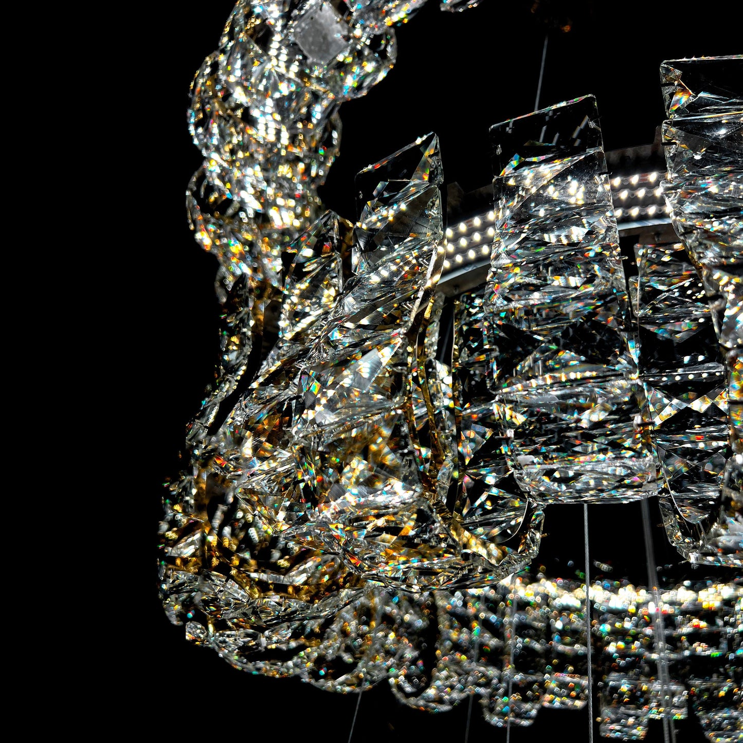 Close-up of a crystal chandelier against a black background