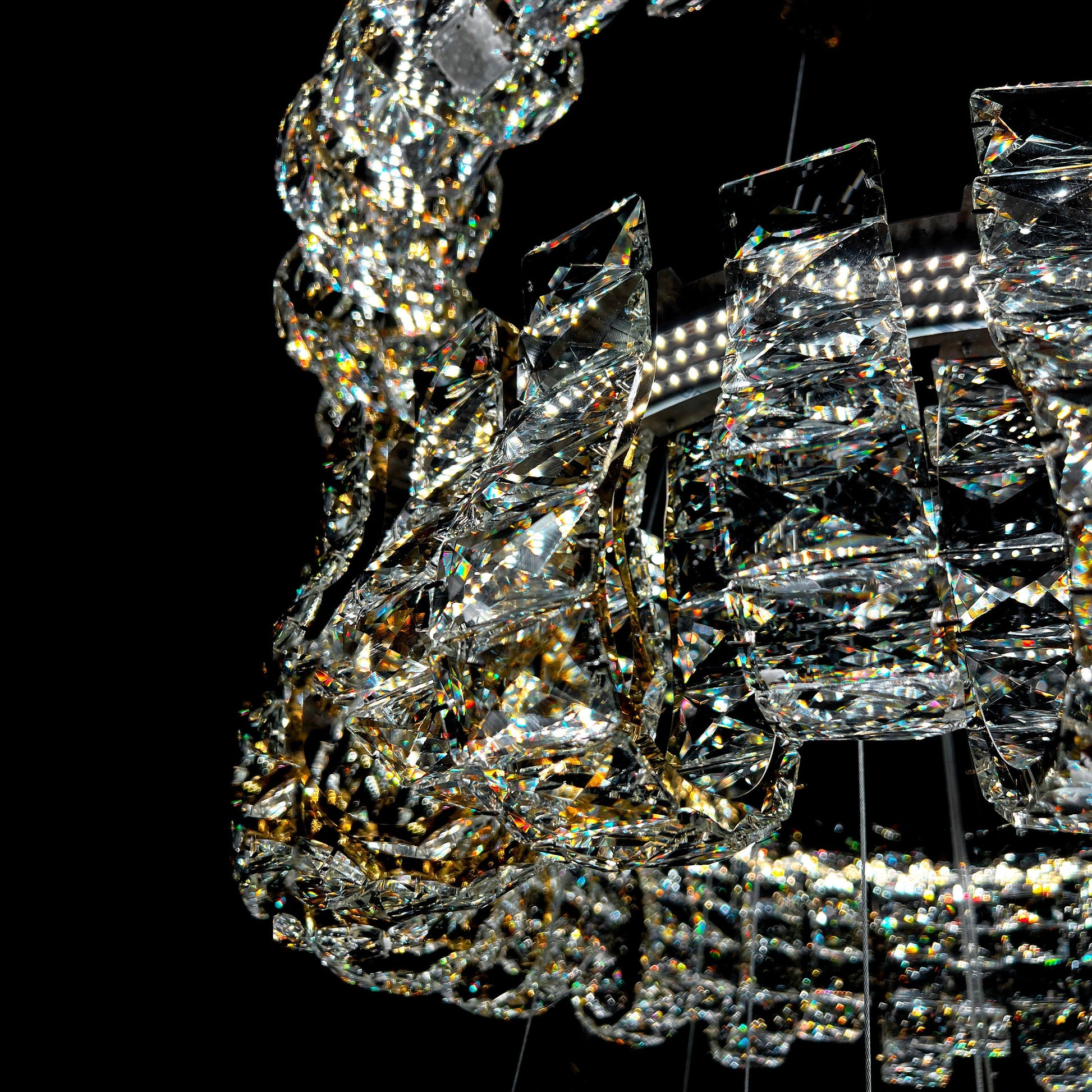Close-up of a crystal chandelier against a black background