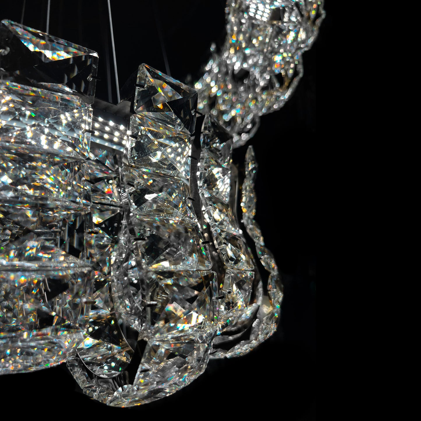 Close-up of a crystal chandelier against a black background