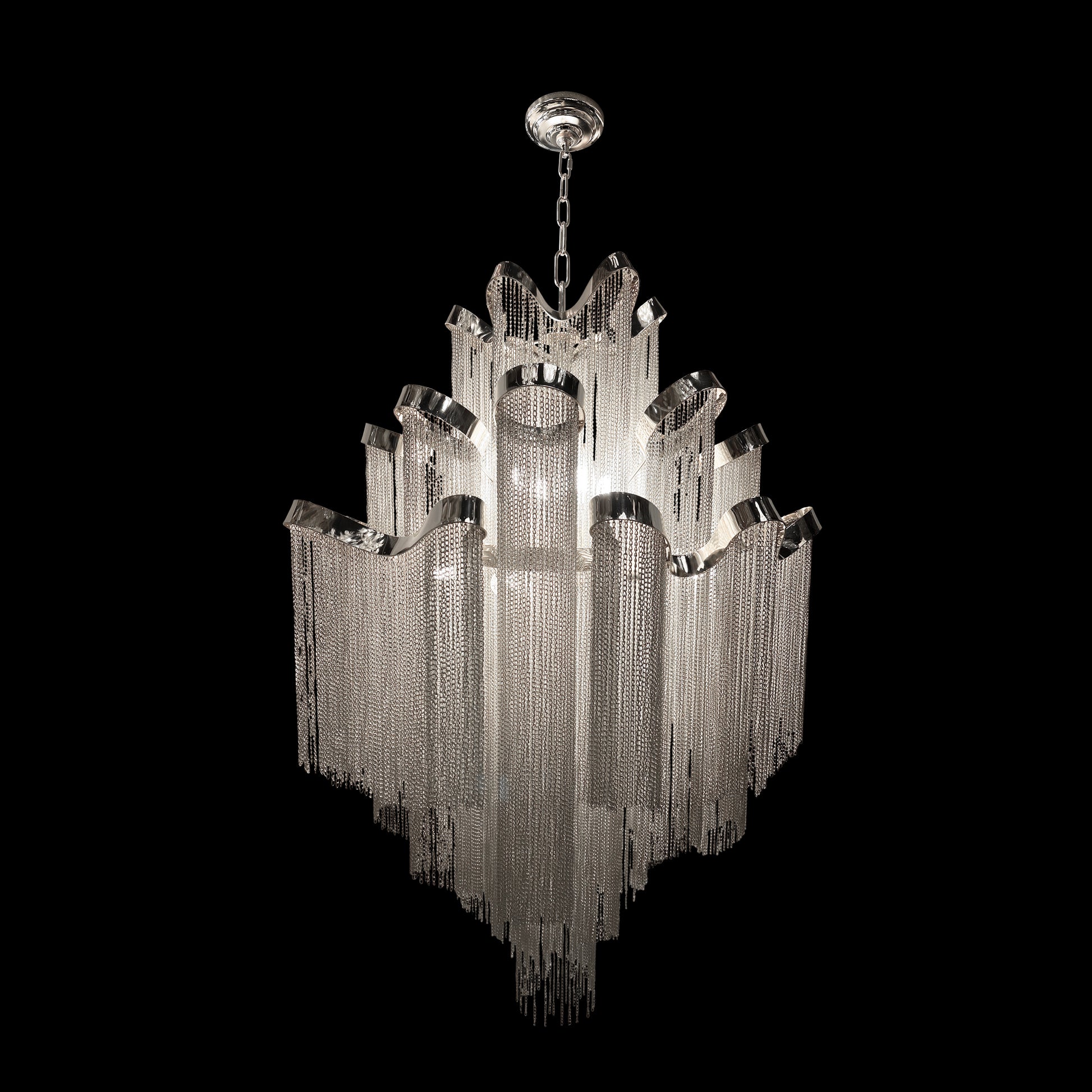 Full view of luxury chrome chain chandelier featuring cascading metal chains in a multi tier waterfall design on a black background.

