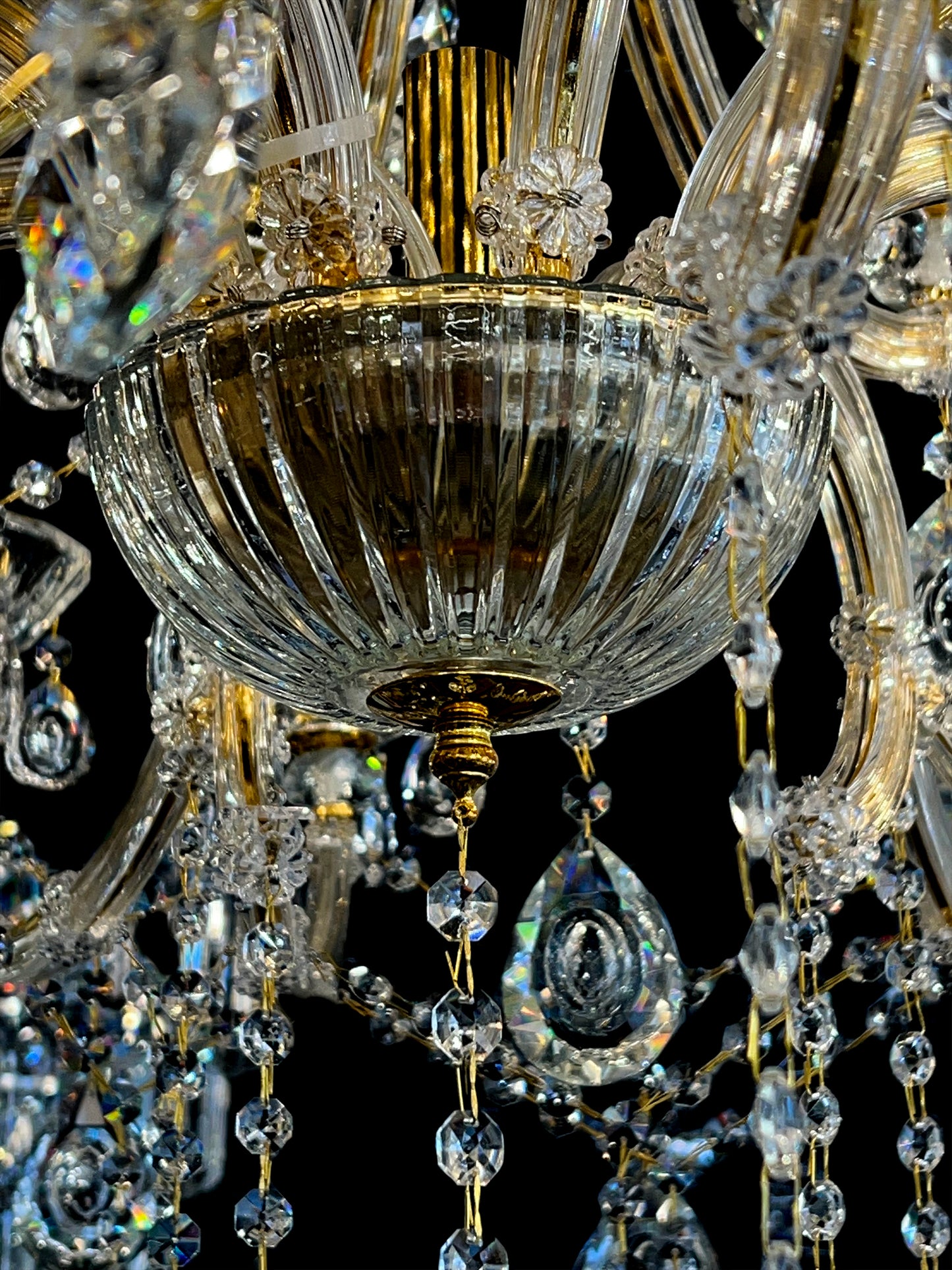 Gold arm and crystal teardrop detailing on 45-inch chandelier