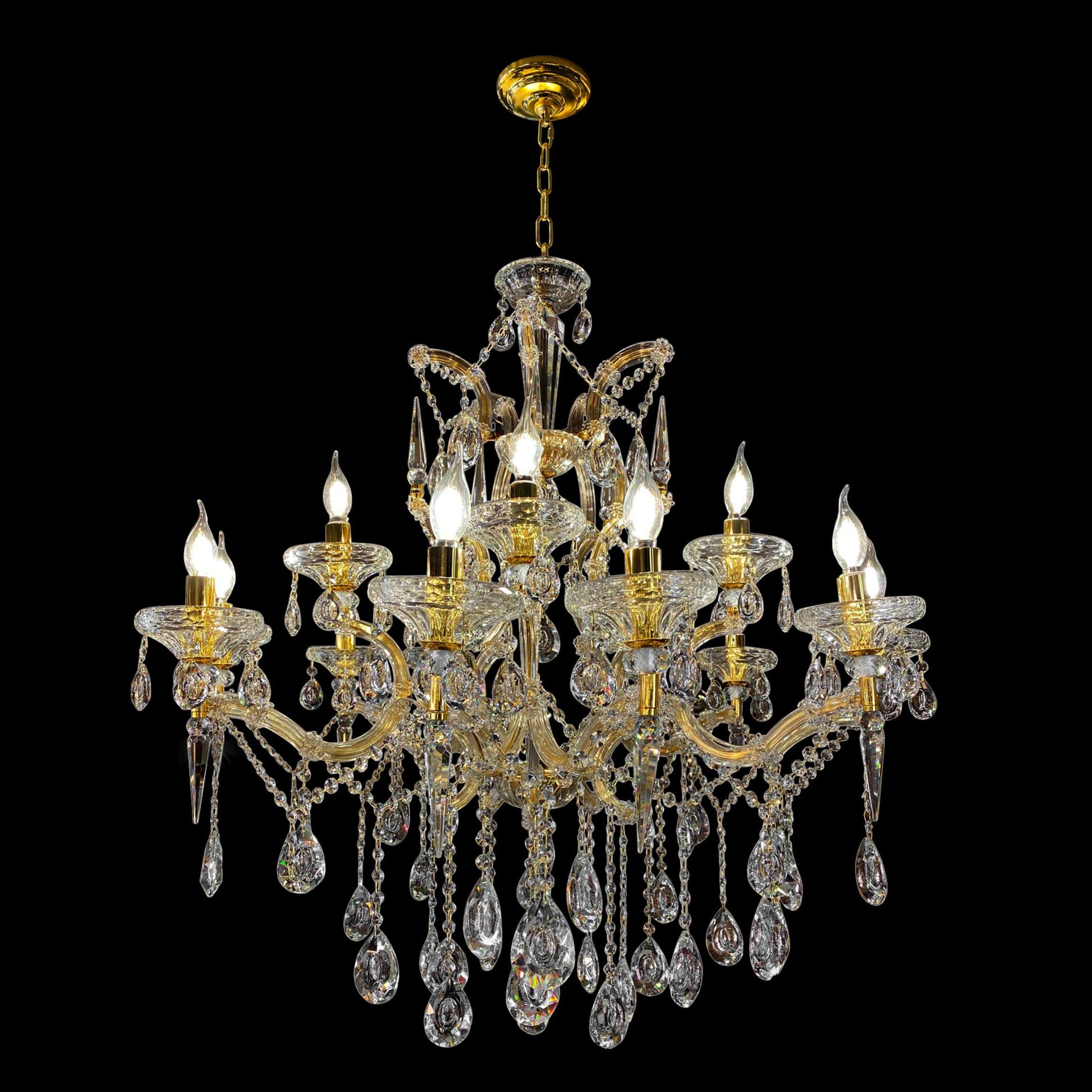 A luxurious gold-finished Maria Theresa crystal chandelier with glass arms and hanging crystal drops.