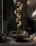 Elegant tall chrome LED wave chandelier installed in high-ceiling living area with cascading illuminated panels
