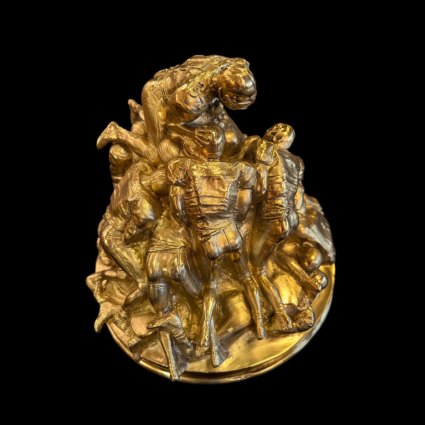 Back view of the handcrafted solid brass American football statue showing the full composition.