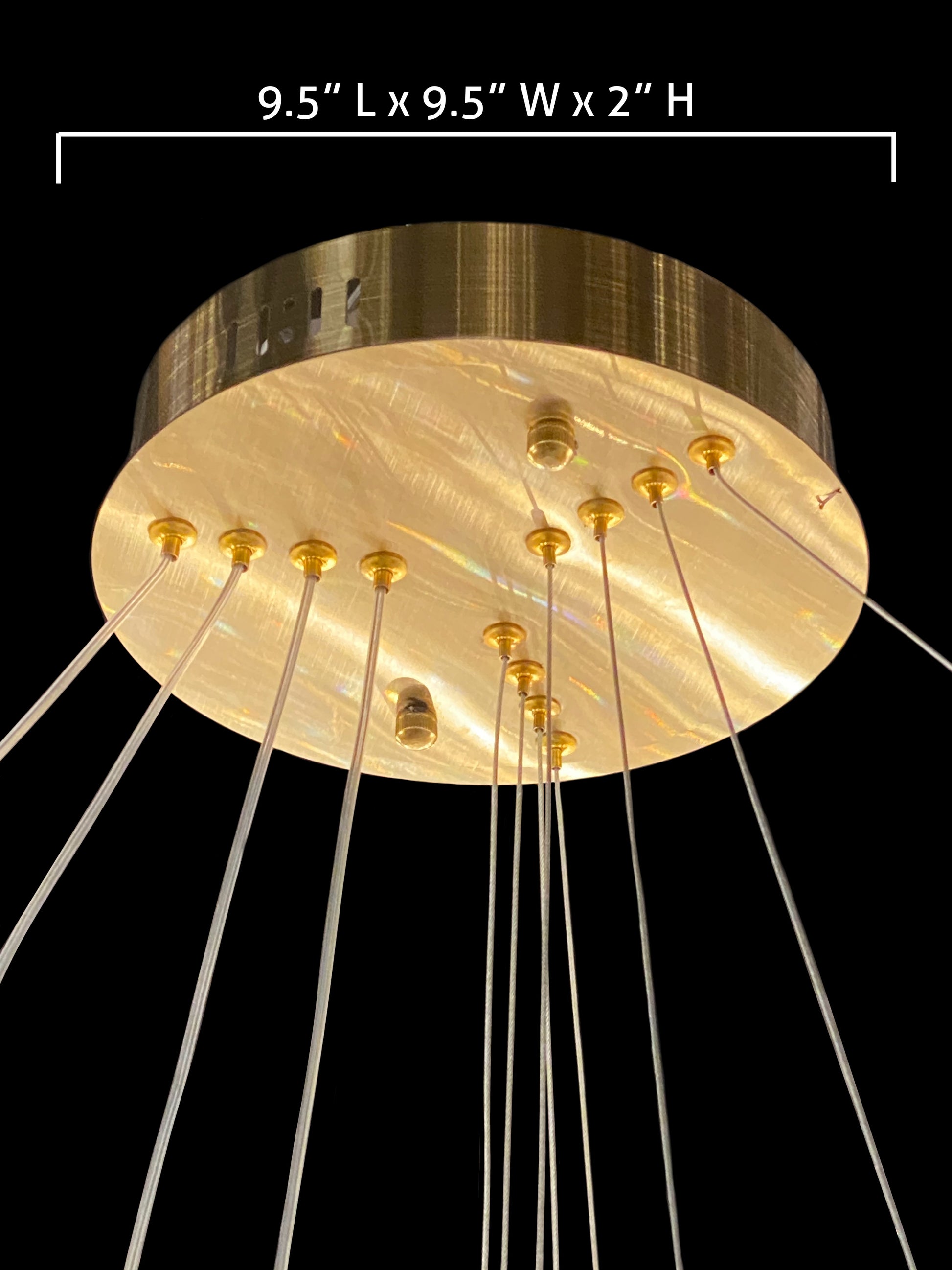 Brushed gold chandelier canopy detail with suspension cables