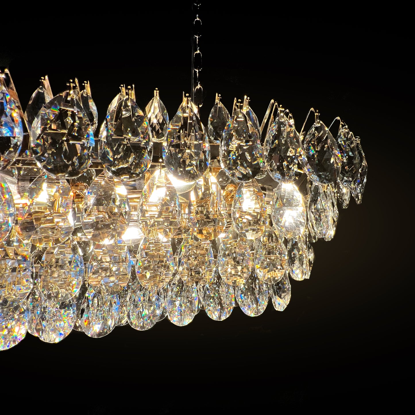 Close-up view of the champagne gold rectangular crystal chandelier showing premium teardrop K9 crystals and golden frame detail