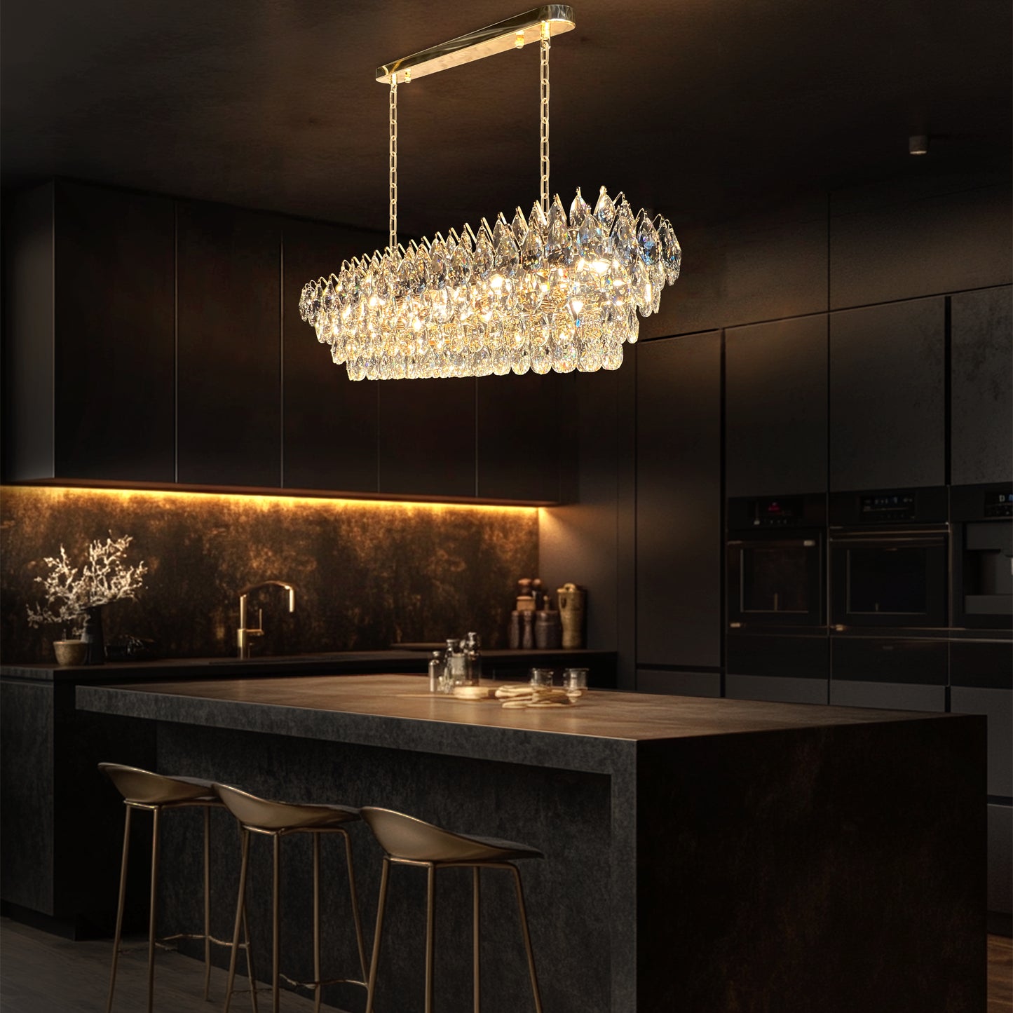 Champagne gold rectangular crystal chandelier with teardrop K9 crystals and a polished linear empire-style design illuminated in warm light.