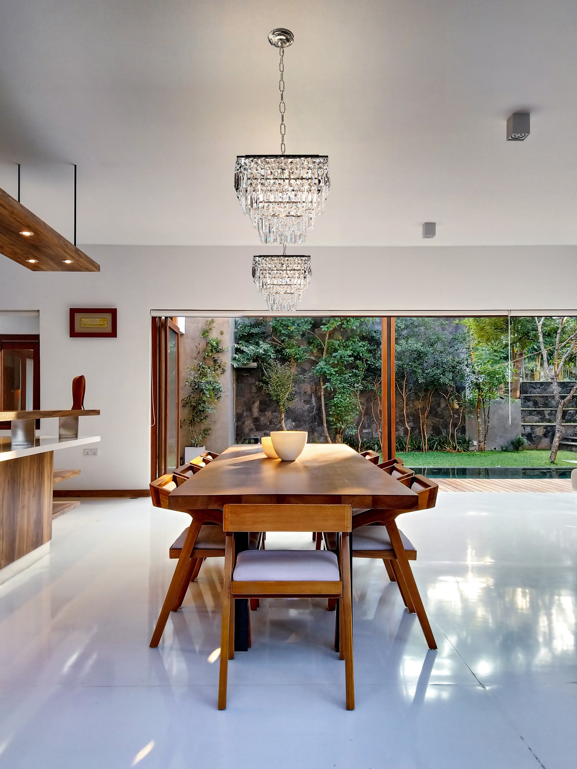 Small chrome crystal chandelier tiered design over dining table