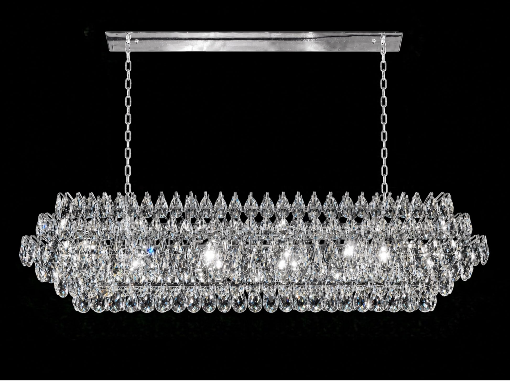 A luxurious 60-inch linear crystal chandelier featuring a polished chrome frame and multiple tiers of precision-cut teardrop crystals, shown hanging from a rectangular canopy with dual chains against a solid black background.
