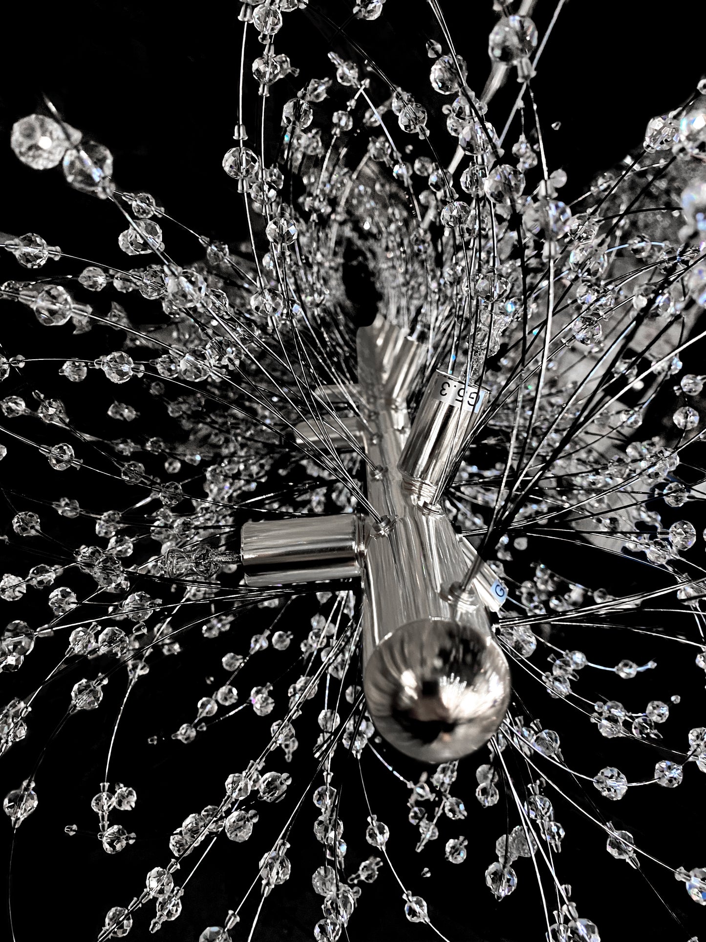 Faceted crystal details reflecting light on chrome frame