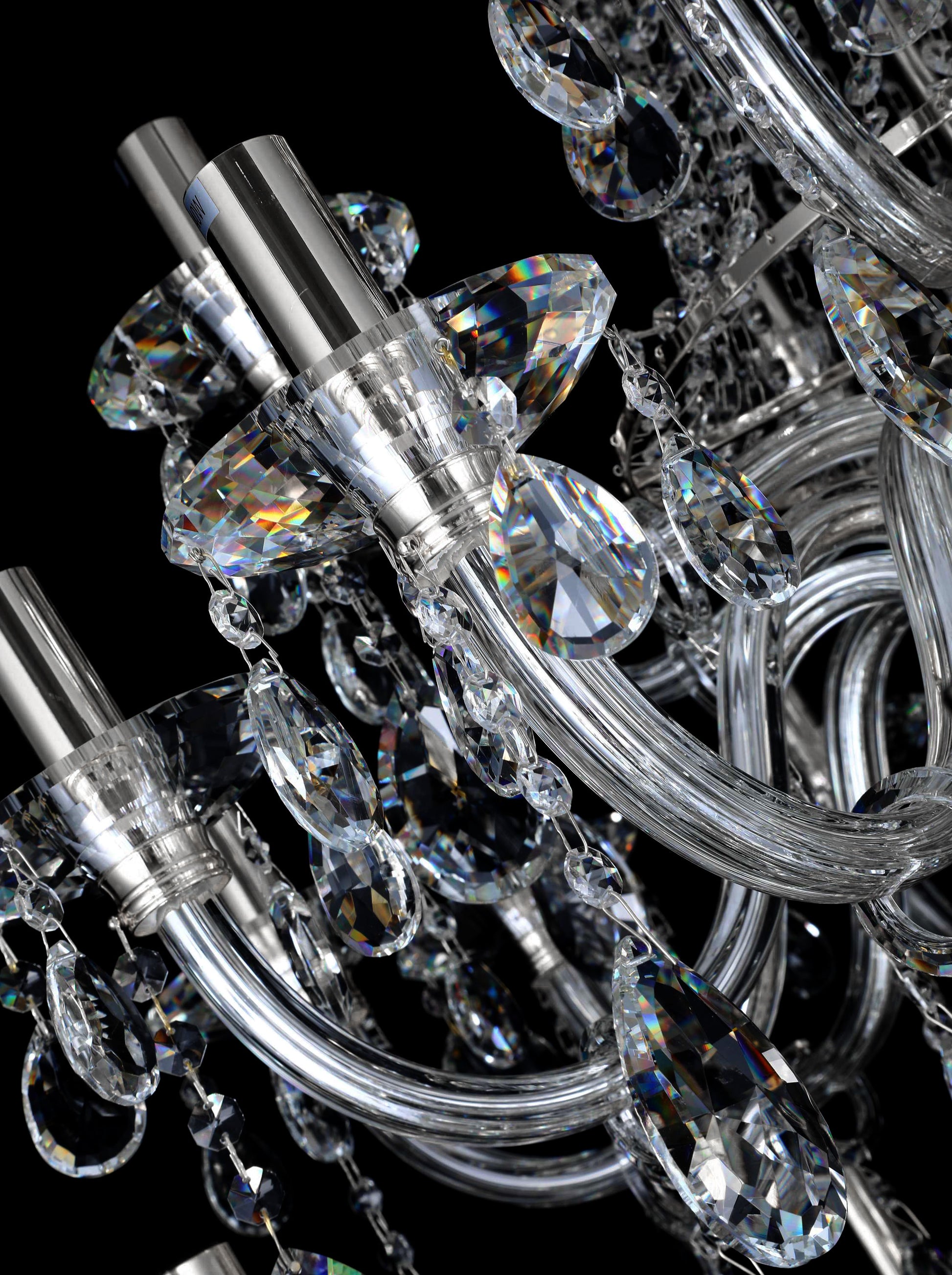 Precision-cut crystal detailing of chrome chandelier showcasing light refraction and clarity.