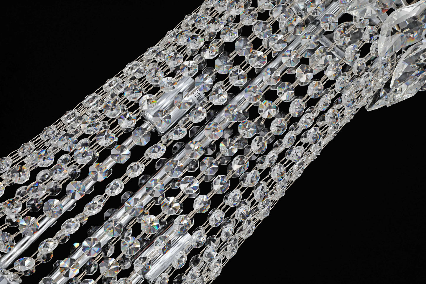 35 inch Close-up of precision-cut crystal strands and chrome accents in a luxury chandelier.
