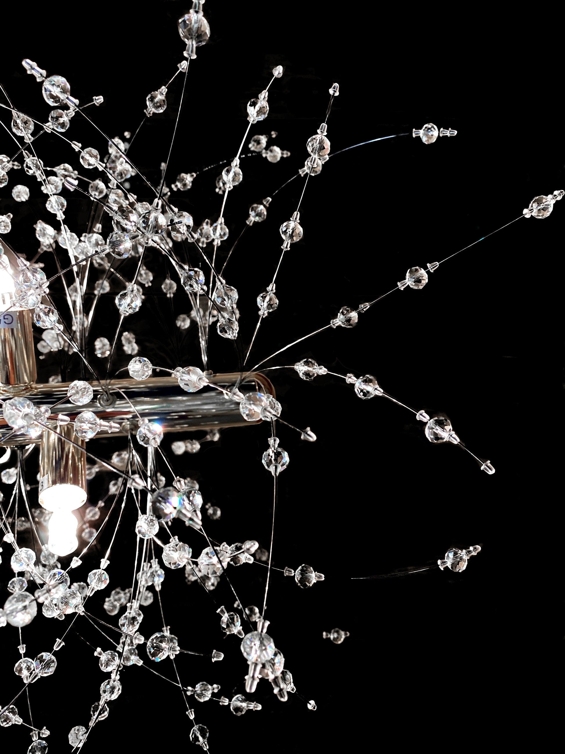 Side view of modern chrome starburst linear chandelier