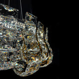 Closeup of luxury K9 crystal chandelier showing intricate gold frame and reflective crystal details.
