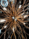 Close-up view of sparkling crystal drops and gold stainless steel branches.