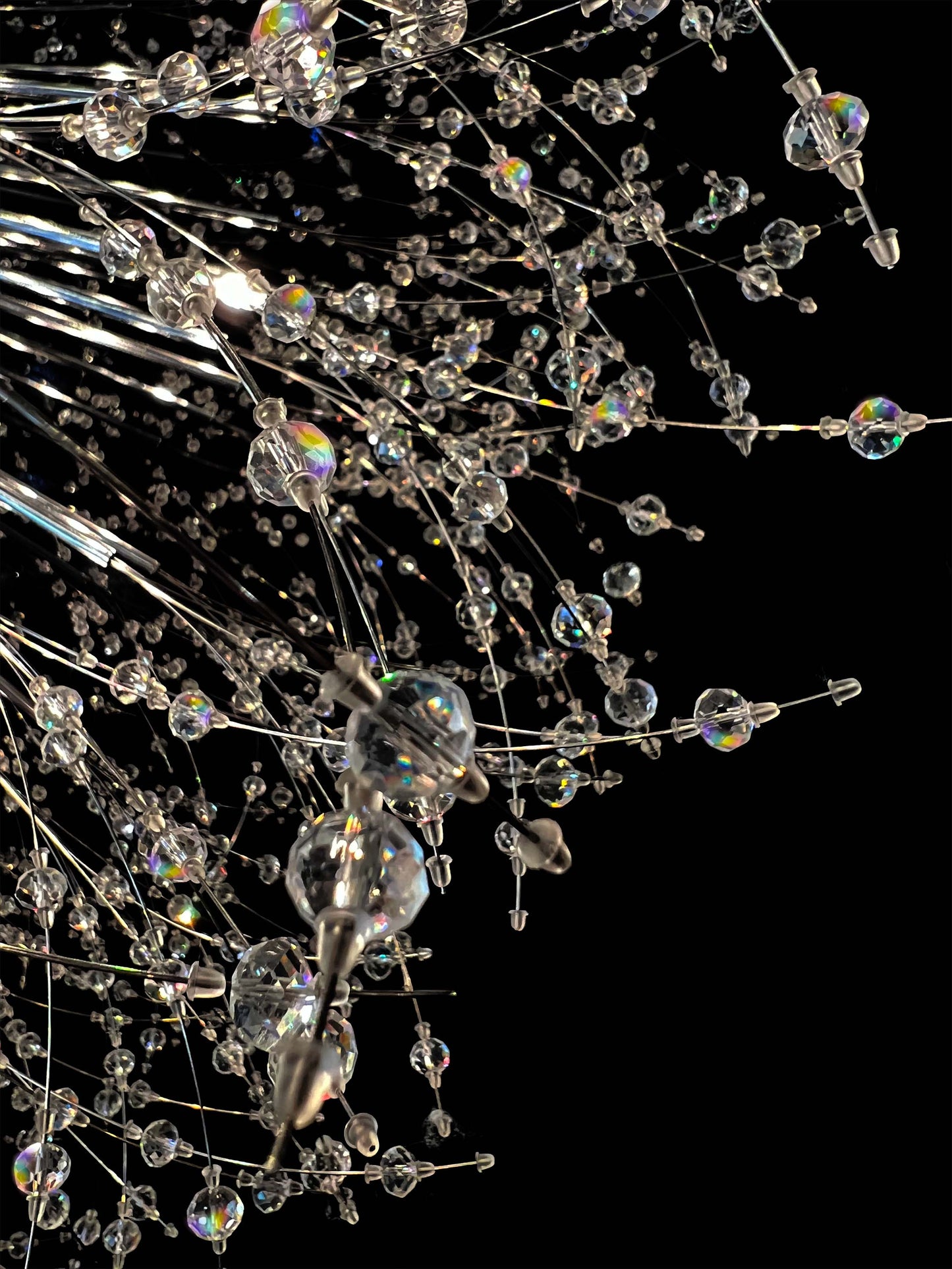 Close-up of precision-cut crystal branches with chrome finish