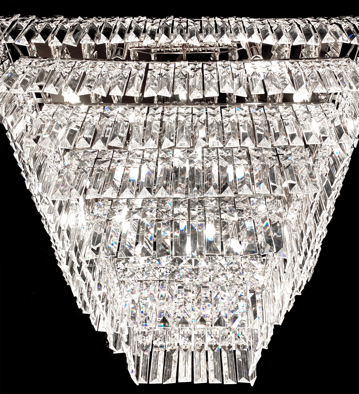 Clear lead crystal prism detail on chrome tiered chandelier
