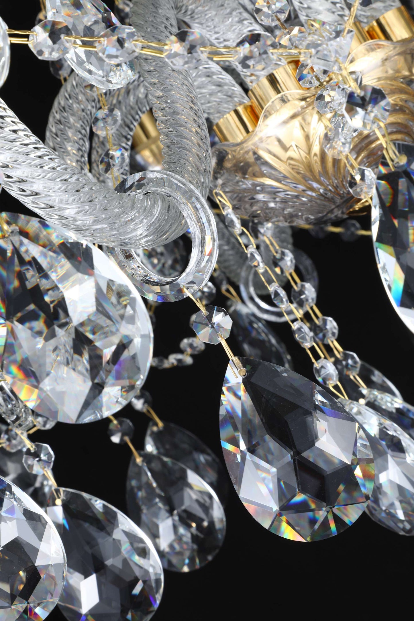 Close-up of 30% lead crystal teardrops on gold chandelier frame