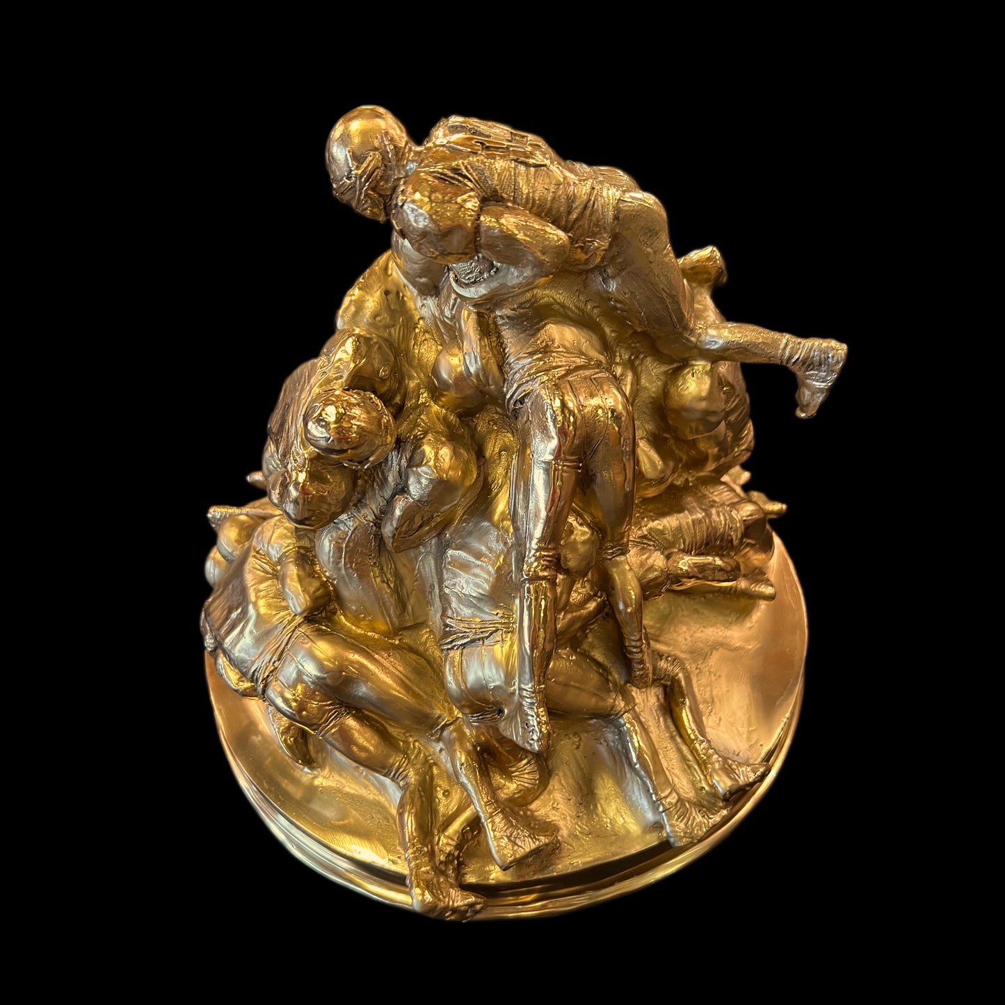 Close-up of the professional craftsmanship on a solid brass American football sculpture made in Italy.