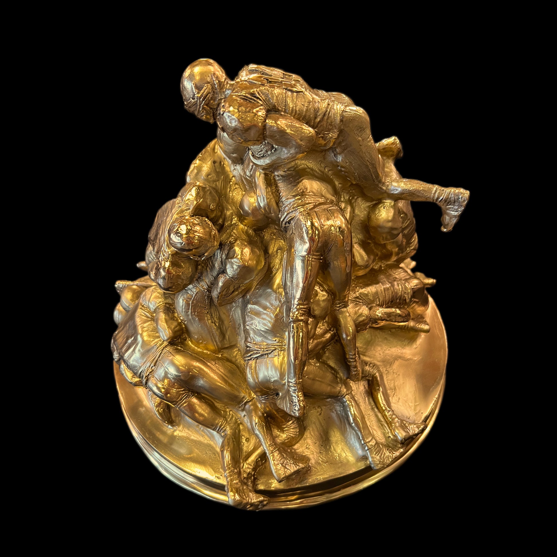 Close-up of the professional craftsmanship on a solid brass American football sculpture made in Italy.