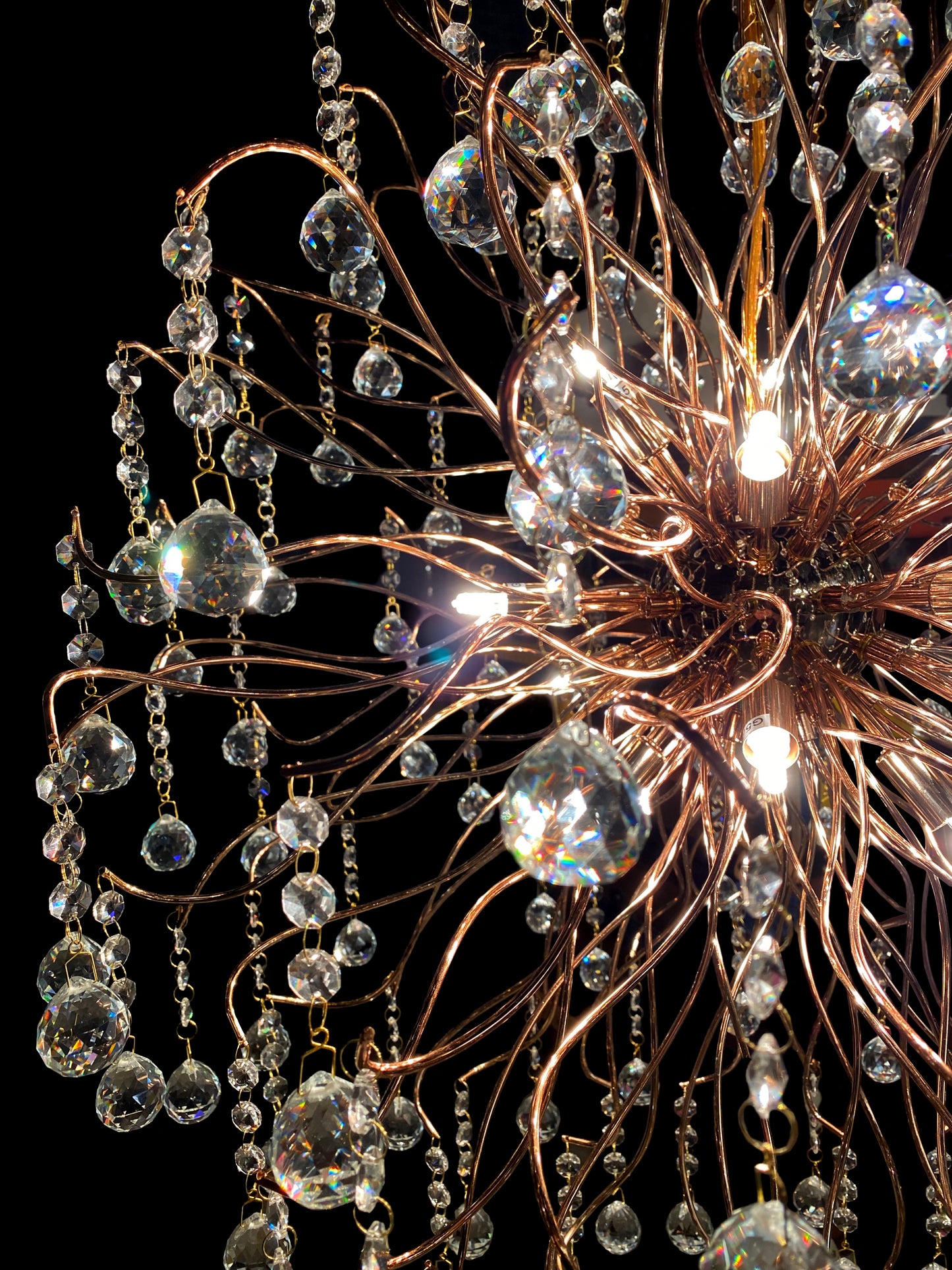 Close-up view of sparkling crystal drops and stainless steel branches.