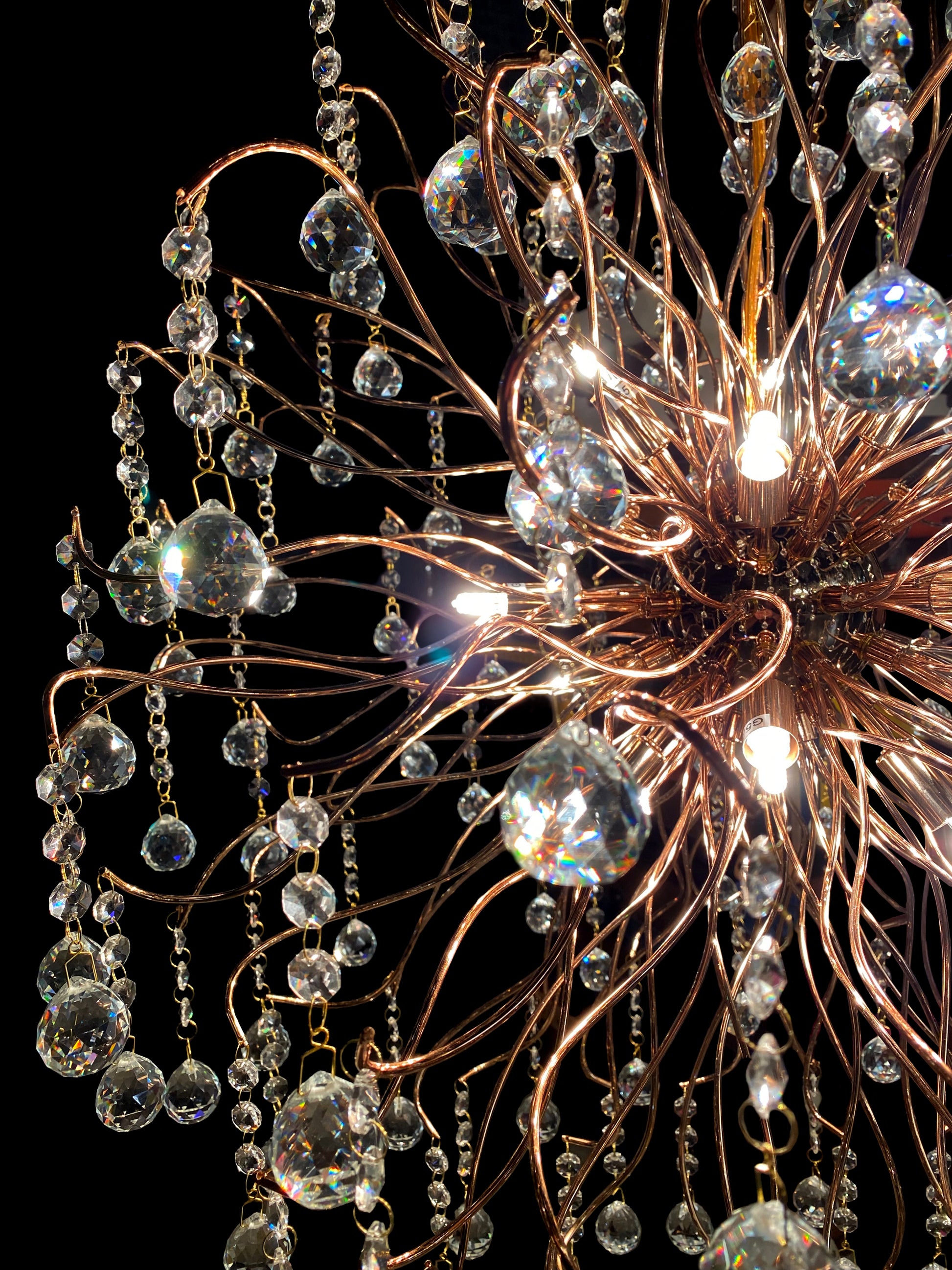 Close-up view of sparkling crystal drops and stainless steel branches.