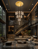 Tall LED cascading crystal chandelier lighting a modern foyer and staircase