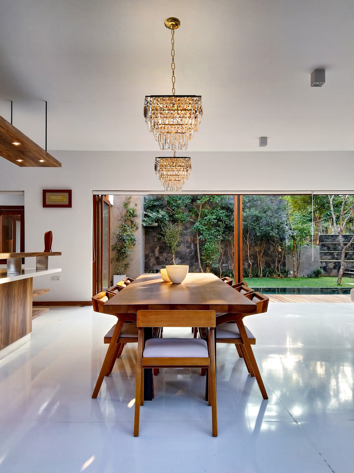 Small gold crystal chandelier tiered design over dining table