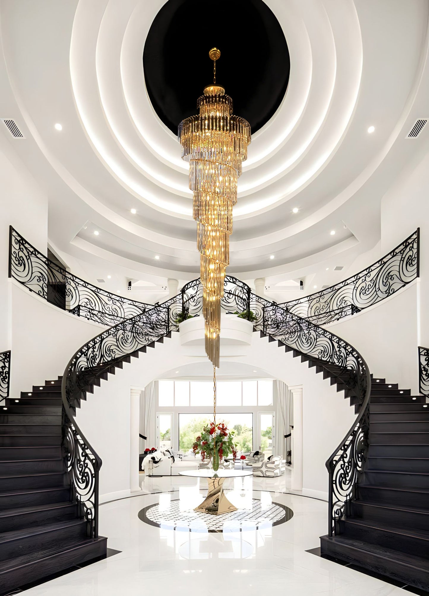 Elegant gold crystal chandelier illuminating grand staircase.