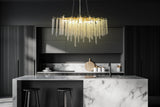 Linear dimmable crystal chandelier illuminating kitchen island