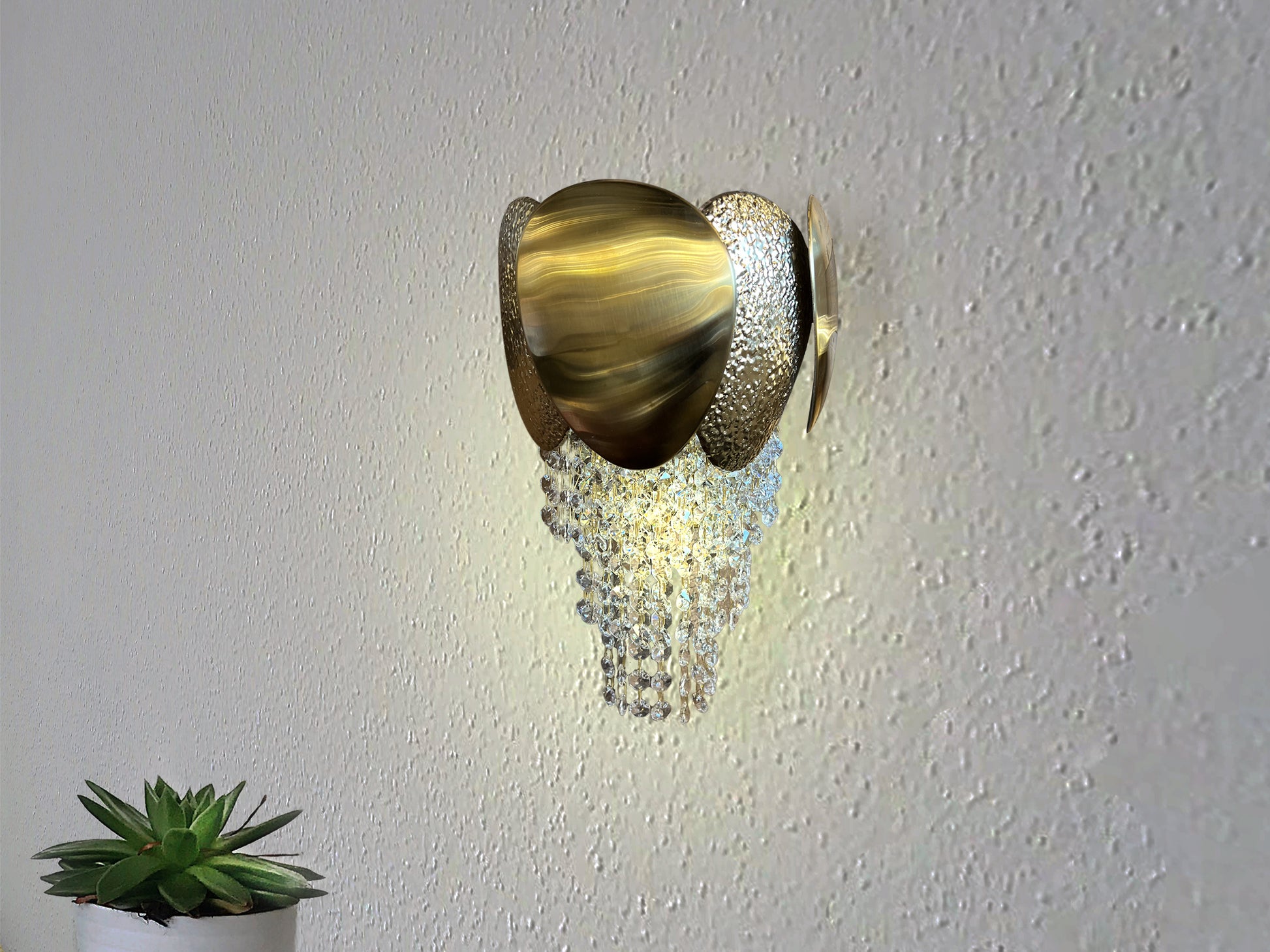 gold crystal led wall light on white interior wall
