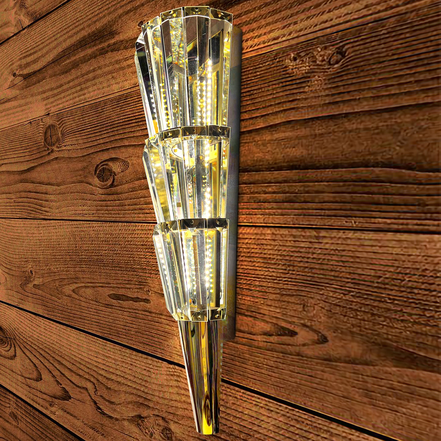 Decorative wall sconce with crystal design on a wooden wall