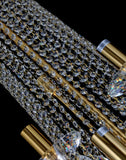 Close-up of precision-cut crystal strands and gold accents in a luxury chandelier.