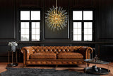 Gold pendant chandelier illuminating a luxurious living room interior.